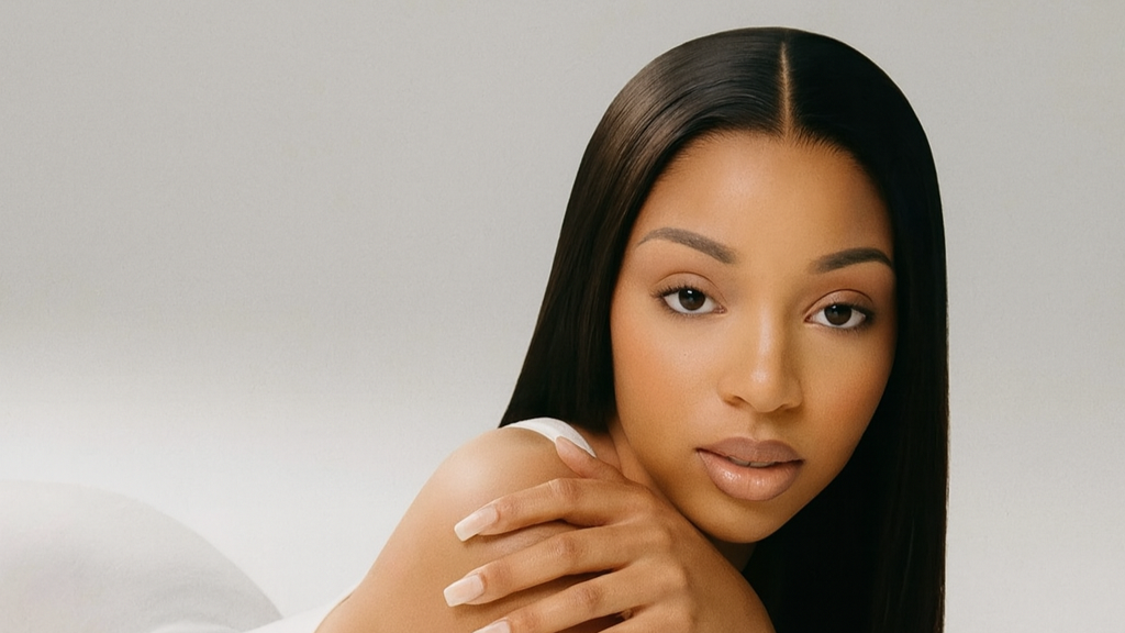 Woman with long, straight black hair against a plain background